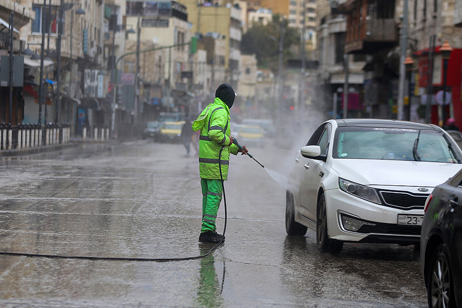 Jordanian authorities disinfecting cars in Amman as part of efforts to confront the COVID-19 pandemic