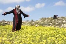 Palestinian woman wearing a traditional dress and enjoying a beautiful spring day