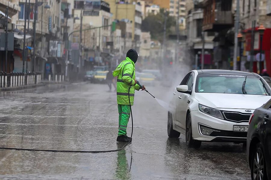 Jordanian authorities disinfecting cars in Amman as part of efforts to confront the COVID-19 pandemic 