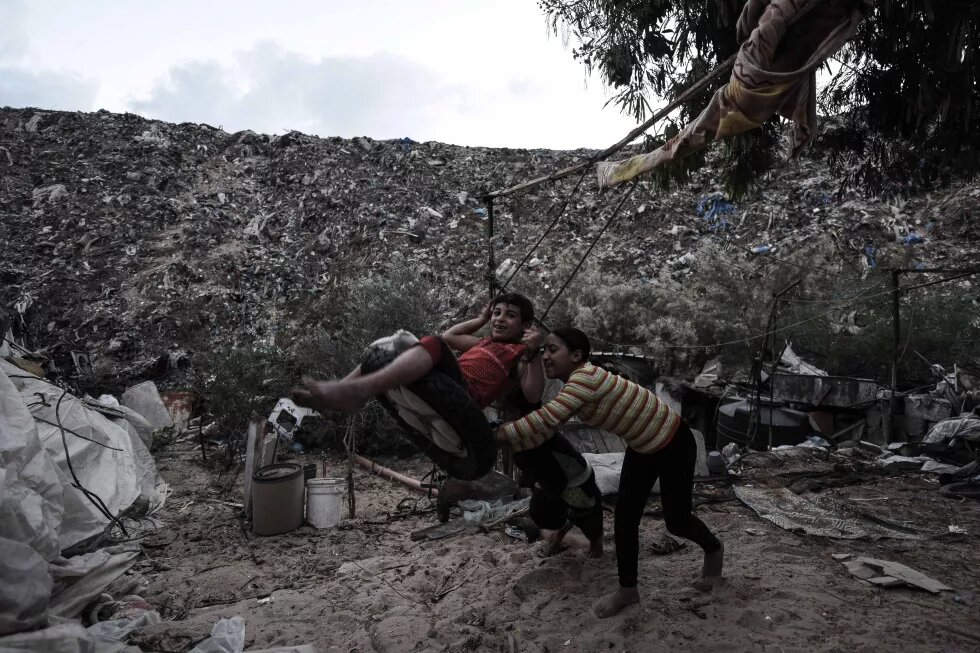 Children playing near their home in Khan Younis, Gaza that is being suffocated by a random dumping site